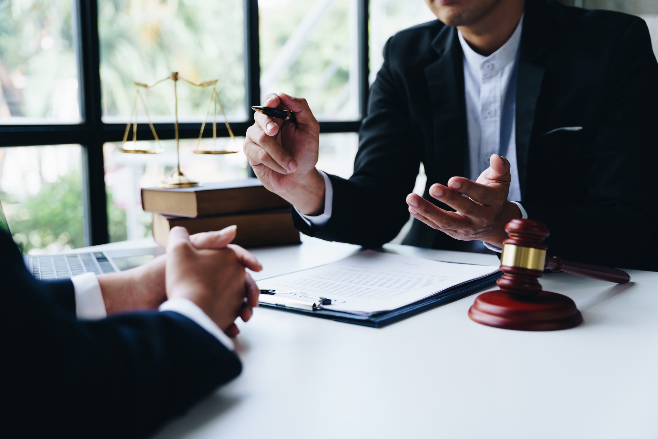 Lawyer discussing case with client in office.